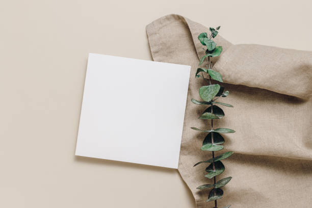 istock Blank paper card on linen cloth and eucalyptus leaves 1419386124
