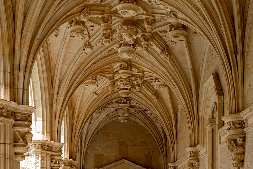 Sunlit gothic corridor cathedral courtyard. Wallpaper