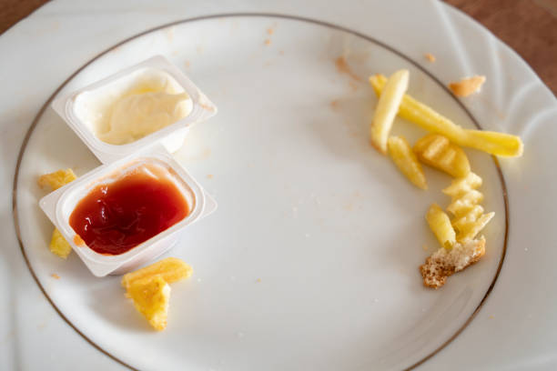 Looking down on a plate with eaten fast food