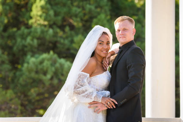 istock Mixed race newlyweds on a walk hugging and looking into the frame 1419388204