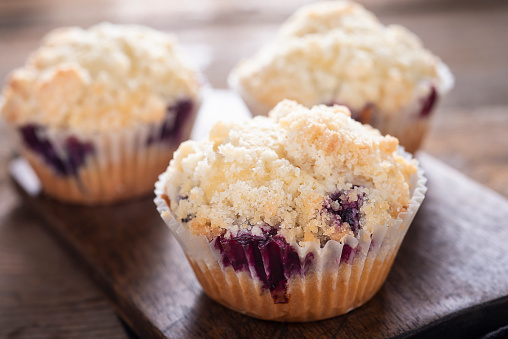 Banana muffins with blueberry on rustic background . Top view , copy space