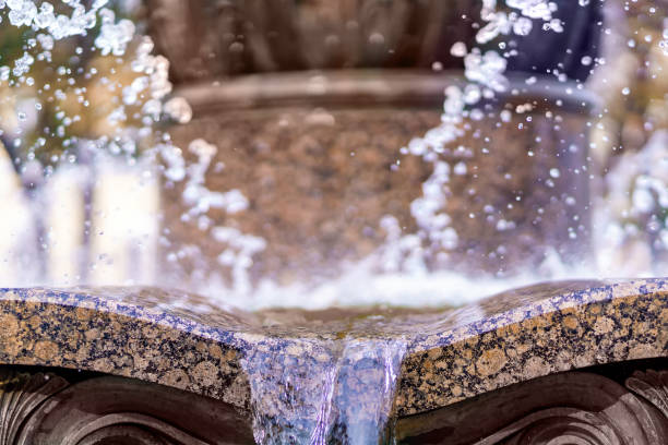 istock Water drains from a curved brown granite stone 1419390870