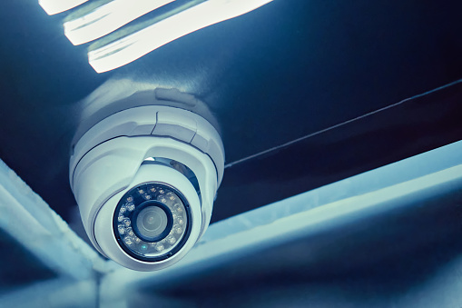 Indoor surveillance security camera in the elevator of a residential building. CCTV camera on an apartment house