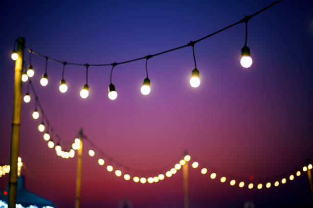 istock vintage light bulbs on string wire in twilight outdoors wedding event party 1419395739