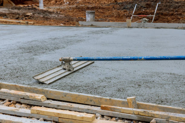 istock A worker is working on a new sidewalk that has just been poured on wet concrete while holding a steel trowel 1419400338