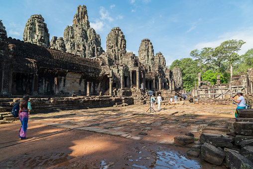 Angkor, Cambodia - January 24, 2020: The Bayon a richly decorated Khmer temple at Angkor in Cambodia. Built in the late 12th or early 13th century as the state temple of the Mahayana Hindu King Jayavarman VII. The Bayon's most distinctive feature is the multitude of serene and smiling stone faces on the many towers.