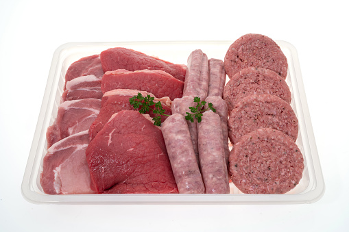 Ground meat in plastic container on white background