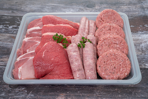 A tray containing a selection of fresh raw meats