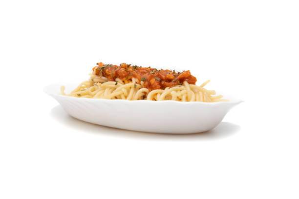 Delicious spaghetti,spaghetti bolognese  served on a white plate, isolated on white background. Bolognese is a sauce very commonly used to accompany pasta. It is a thick, brownish-red sauce.
