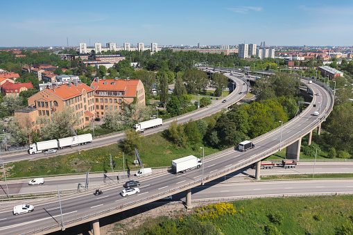 Highway traffic at an intersection with various cars and trucks in Stockholm, Sweden.
