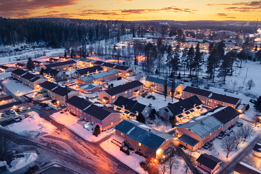 A residential area with row houses and apartment buildings on a winter evening in Grängesberg, in the Dalarna region of Sweden.