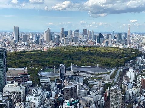 The highrise buildings of Shinjuku, Tokyo, with Yoyogi Park in the foreground, taken from Shibuya