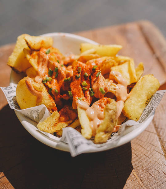 A portion of Spanish patatas bravas with spicy sauce A portion of Spanish patatas bravas with spicy sauce patatas bravas stock pictures, royalty-free photos & images