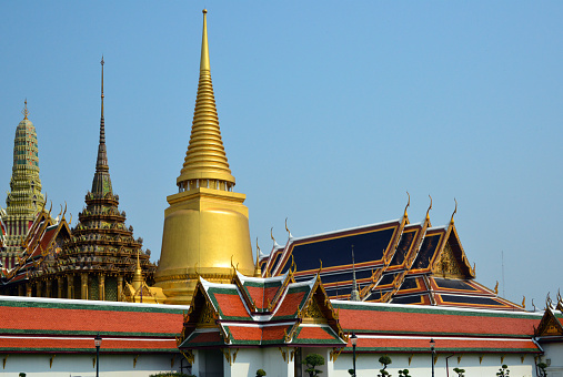 Bangkok, Thailand: Wat Phra Kaew / Temple of the Emerald Buddha, national shrine for the monarchy and the state - Thai temple architecture: Phra Si Rattana Chedi / stupa, Phra Mondop, prang of the Prasat Phra Thep Bidon (Royal Pantheon) and the Phra Ubosot, or ordination hall.