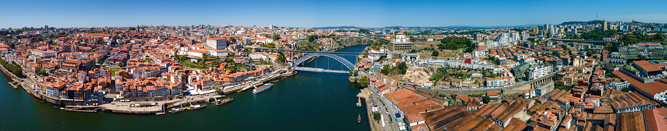 A scenic view of the Douro River, three bridges, and the city of Porto on a sunny day.