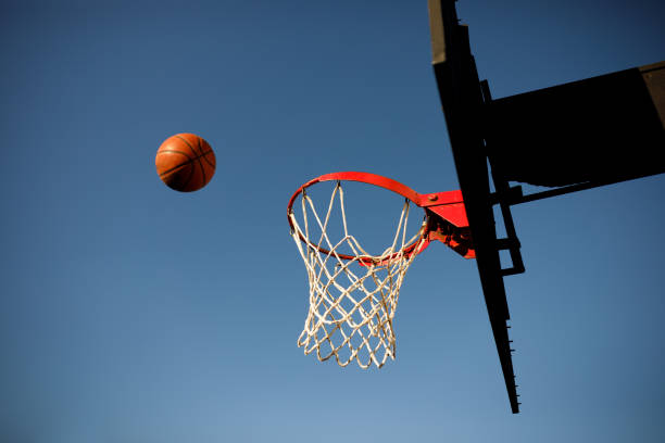 Basketball thrown in the air to a hoop Basketball practice back board basketball stock pictures, royalty-free photos & images