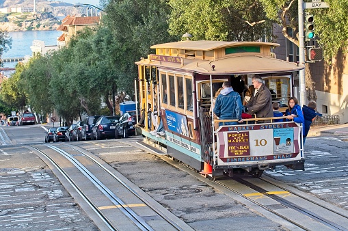The steep slope of Hyde street and the famous cable cars climbing through the Fort Mason and the Francisco park districts of San Francisco California in November 2009.