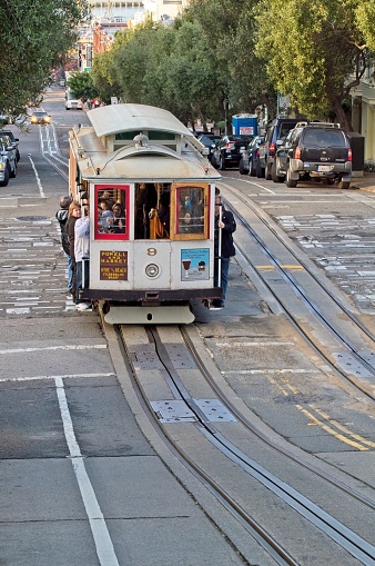 The steep slope of Hyde street and the famous cable cars climbing through the Fort Mason and the Francisco park districts of San Francisco California in November 2009.