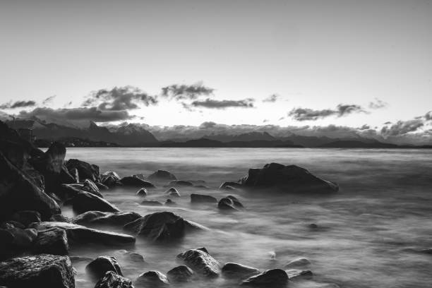rocks in the water in a nostalgic and beautiful sunset