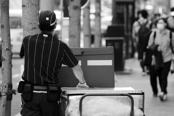 Parcel service worker pushing a cart in downtown Kyoto stock photo