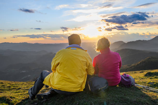 istock People relaxing in mountains, couple admiring romantic sunset time 1419448317