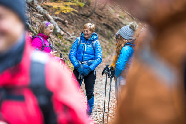 istock Female hikers standing in group in forest and chatting 1419448318