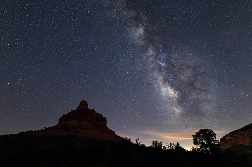 The Milky Way galaxy and starry night sky over Bell Rock in Sedona, Arizona, USA.