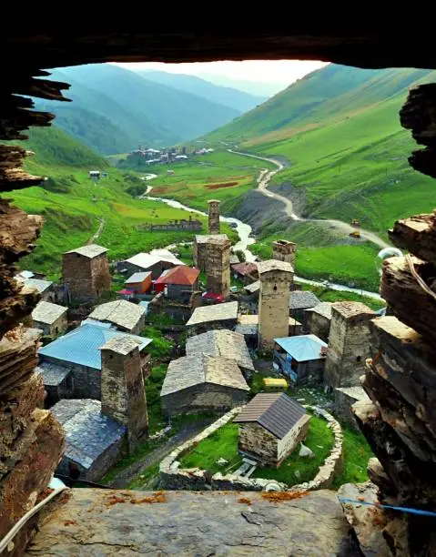 The town of Ushguli in the Svaneti region of Georgia being seen through the window of an ancient tower