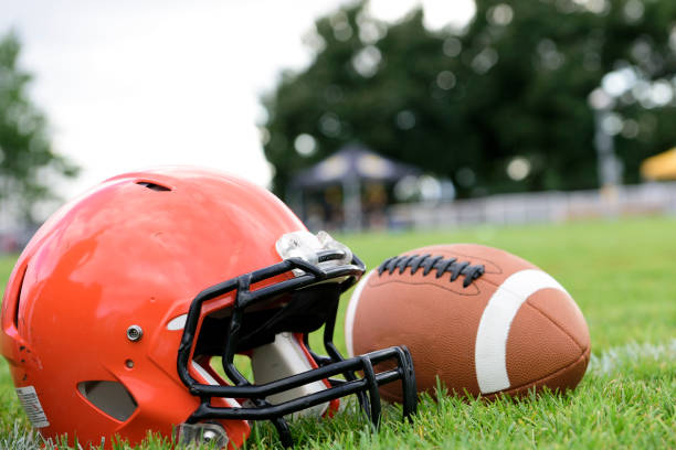 istock Helmet and football on grass 1419461477