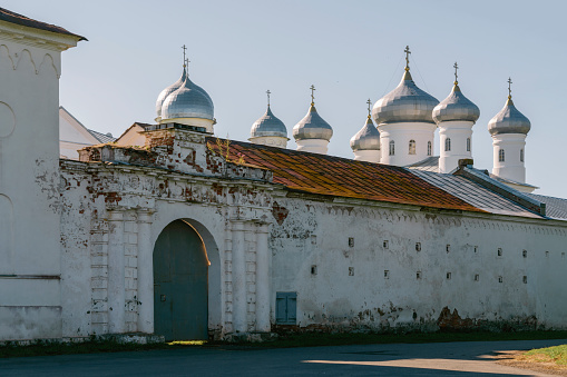 View of the wall of St. George (Yuryev) Monastery and the domes of Spassky Cathedral on a sunny summer day, Veliky Novgorod, Russia