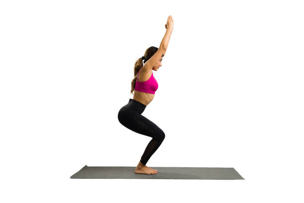 istock Hispanic young woman practicing a chair yoga pose 1419462750