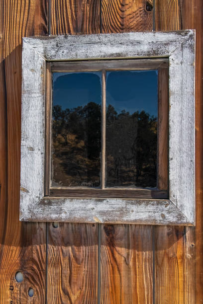 istock Weathered old wooden barn window in bright light 1419463722