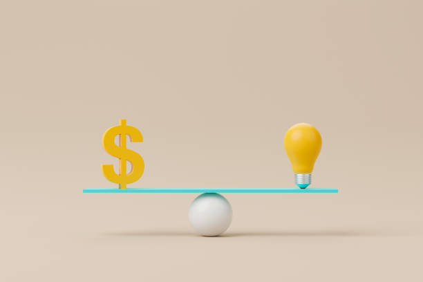istock Dollar sign and light bulb on scale seesaw. Balance scale on background. 3d illustration 1419465448