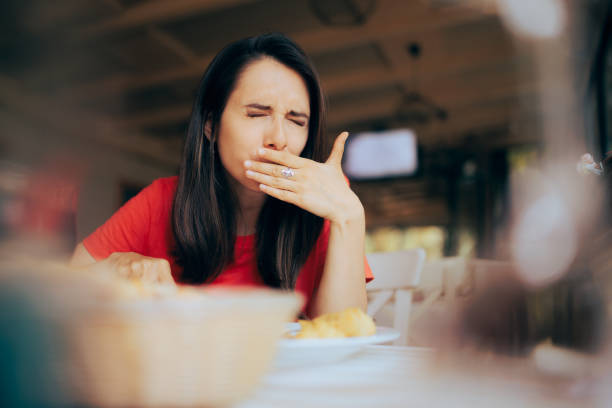 Woman Feeling Sick and Disgusted by Food Course in a Restaurant Unhappy person having health problems after eating in a diner toothache stock pictures, royalty-free photos & images