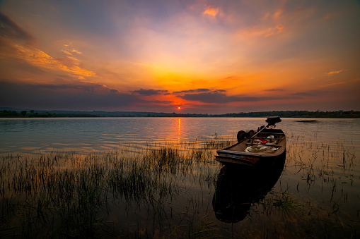 Native fisherman boat at The Lake on Sunset.Sunset over Lake , Sisaket province, Thailand,ASIA.