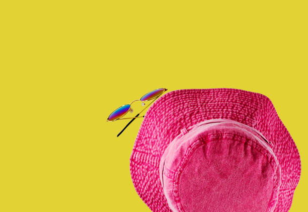 A pink red hat with Sunglasses isolated on colored background