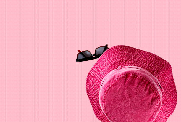 istock A pink red hat with sunglasses isolated on colored background 1419475449