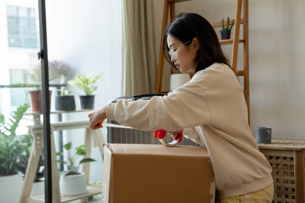 istock Young woman preparing for moving into student accommodation. 1419485689