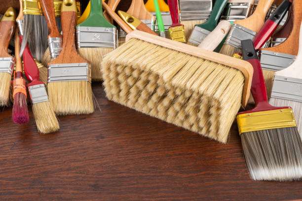 istock Paint Brushes on Wooden Table 1419489659