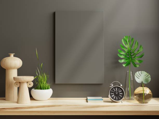 istock Mockup frame on wooden shelf in living room interior on empty dark wall. 1419490630