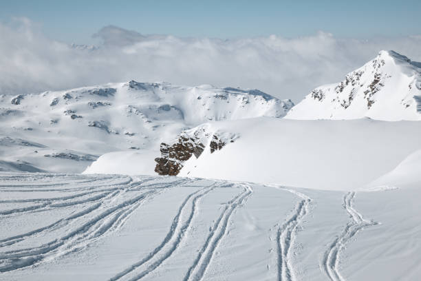 Snowcapped mountains with fresh ski tracks in Val Thorens, France.