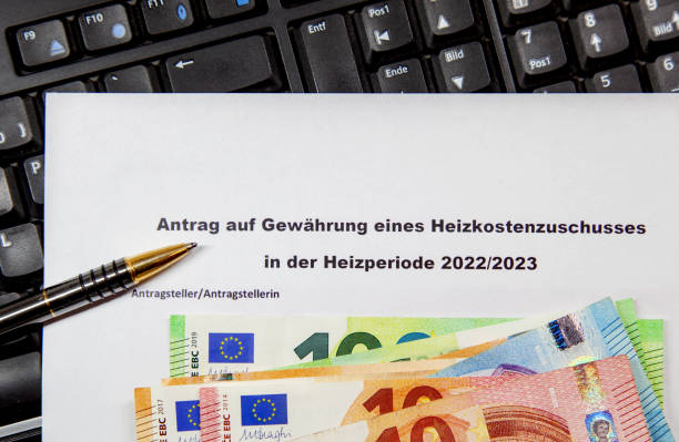 istock German application form allowance for heating allowance, Money and a ballpoint pen 1419495679