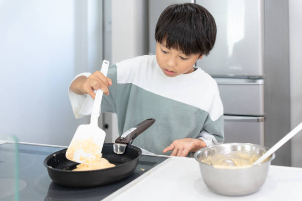 istock Asian boy cooking in the kitchen at home 1419498850