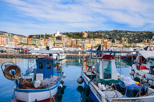 Ancient pastel-colored buildings are lined up along the marina of Santa Margherita Ligure