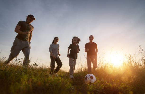 istock Happy family playing soccer 1419499823