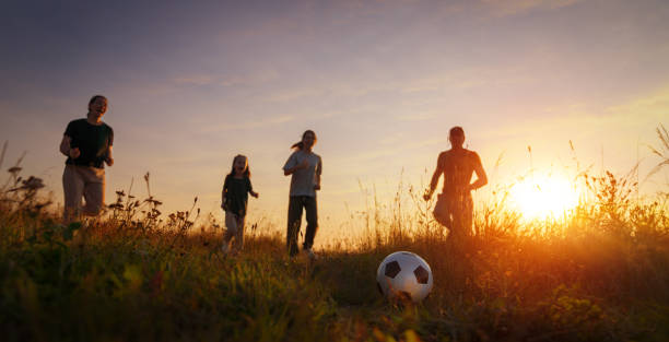 istock Happy family playing soccer 1419499825