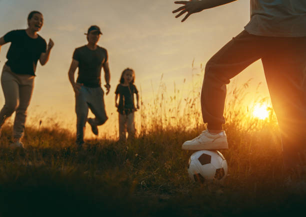 istock Happy family playing soccer 1419499833