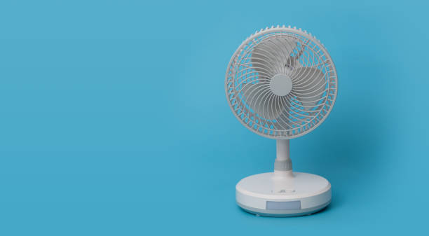 istock White desktop electric fan on blue background. 1419500925