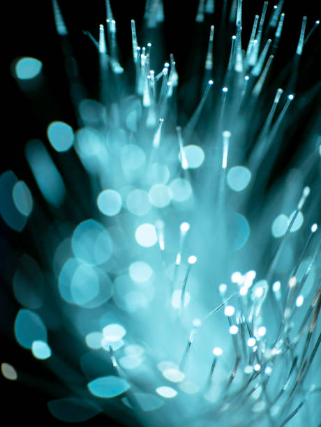 istock Optical fiber network cable on black background, abstract light sparkler 1419504602