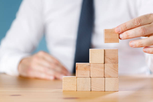 istock Businessman arranging wood block stacking. Business concept for growth success process 1419504622